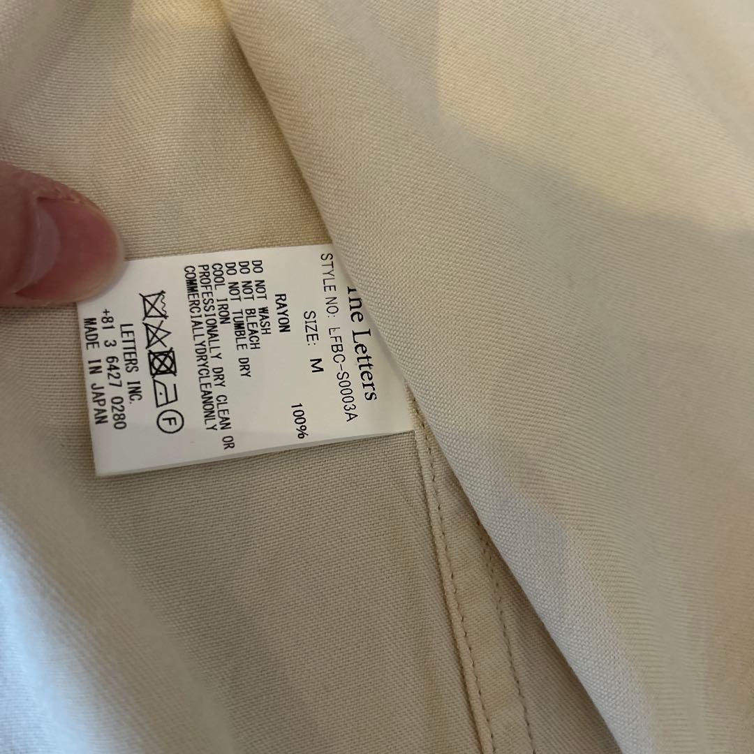 トップス The letters Western smile pocket Msize