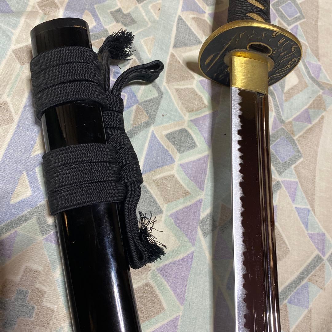 上級居合刀 黒柄 鶴波図楕円鍔 黒呂鞘