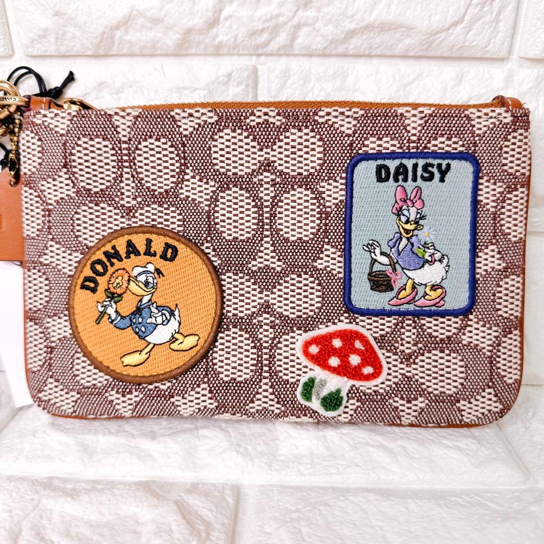 タグ付【未使用】COACH ポーチ シグネチャー ディズニー ドナルド デイジー