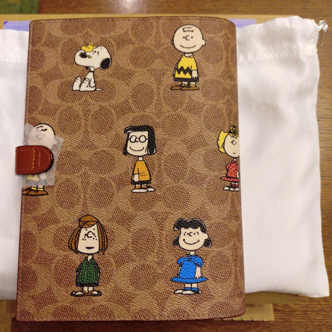 コーチ　スヌーピーコラボ　ノートブックシグネチャーキャンバス