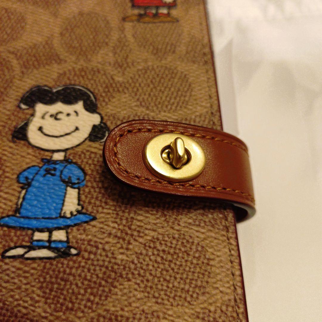 コーチ　スヌーピーコラボ　ノートブックシグネチャーキャンバス