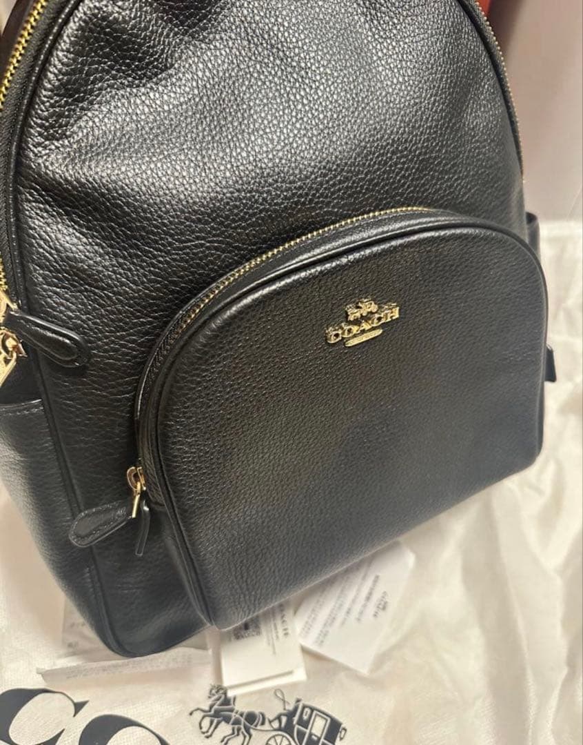 バッグ COACH PEBBLED LEATHER COURT BACKPACK